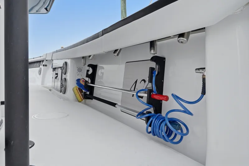 Slide: The Image of 2025 Yellowfin 42 Offshore boat interior with storage and cleaning equipment. - 28