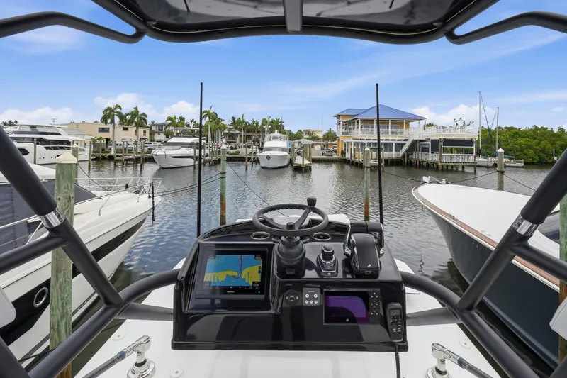 Slide: The Image of Cockpit view of 2025 Yellowfin 42 Offshore boat docked at a marina. - 54
