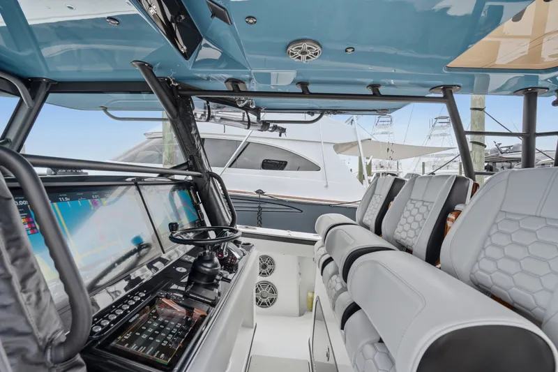Slide: The Image of Interior view of 2025 Yellowfin 42 Offshore boat with advanced navigation system and luxurious seating. - 46