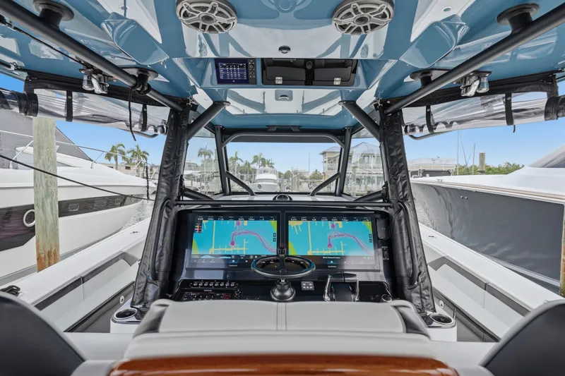 Slide: The Image of Interior view of 2025 Yellowfin 42 Offshore boat cockpit with advanced navigation displays. - 44