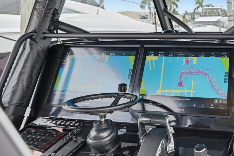 Slide: The Image of 2025 Yellowfin 42 Offshore boat dashboard with dual Garmin navigation screens. - 60