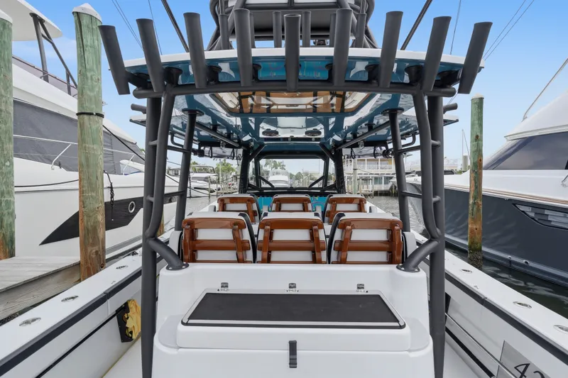 Slide: The Image of 2025 Yellowfin 42 Offshore boat interior with seating, docked at marina. - 43