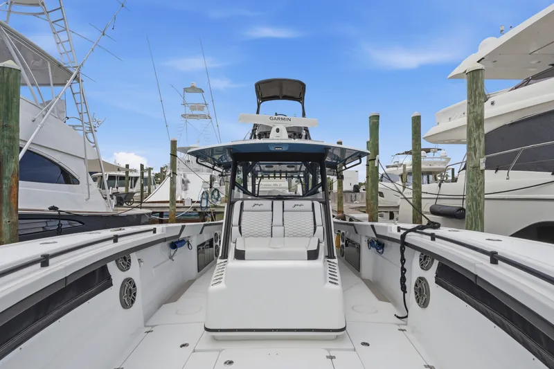 Slide: The Image of 2025 Yellowfin 42 Offshore boat docked at marina, showcasing spacious deck and modern design. - 52
