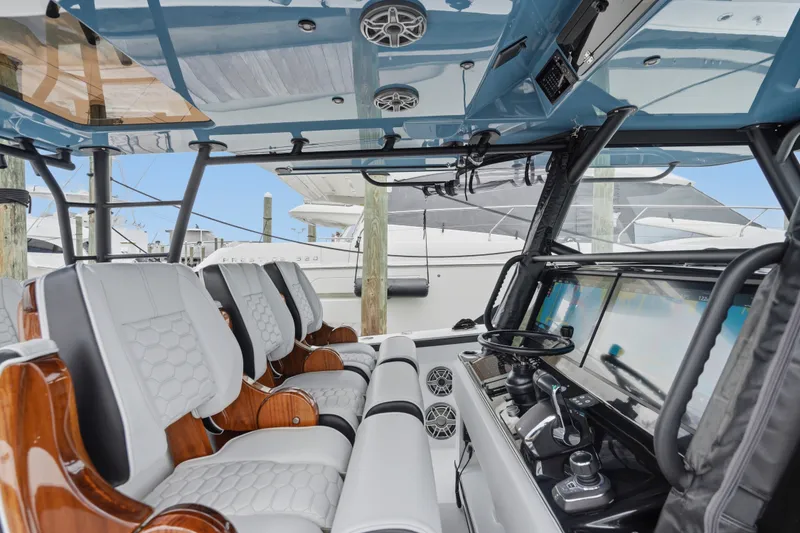 Slide: The Image of 2025 Yellowfin 42 Offshore boat interior with modern seating and advanced navigation controls. - 48