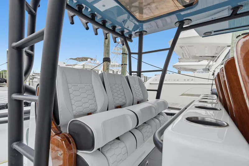 Slide: The Image of 2025 Yellowfin 42 Offshore boat interior with luxurious seating and rod holders. - 49