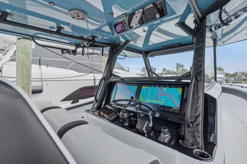 Slide: The Image of 2025 Yellowfin 42 Offshore boat cockpit with advanced navigation displays and controls. - 47