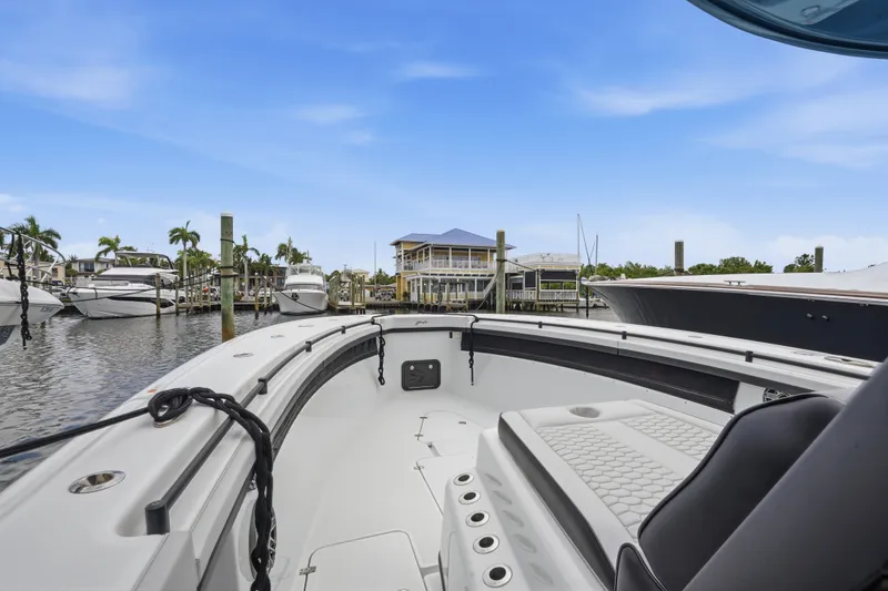 Slide: The Image of 2025 Yellowfin 42 Offshore boat docked in a marina with clear blue skies. - 51