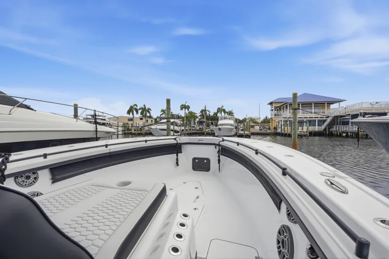 Slide: The Image of 2025 Yellowfin 42 Offshore boat docked in a marina with clear blue skies. - 53