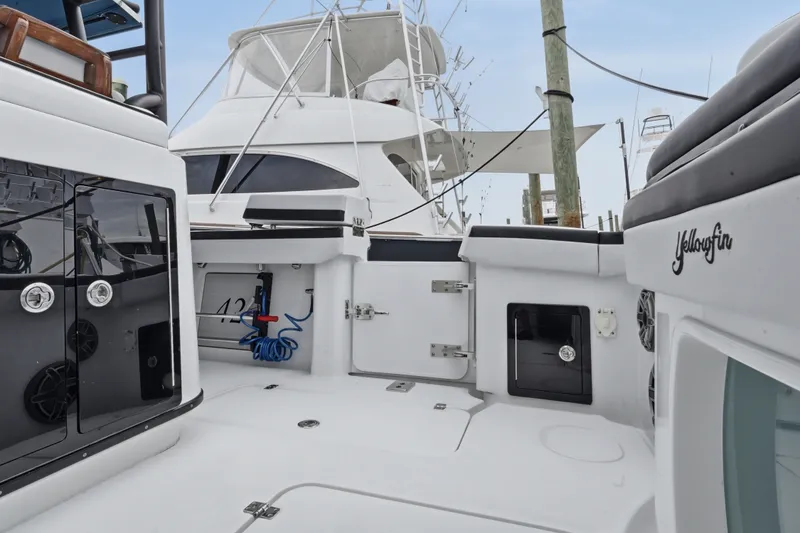 Slide: The Image of 2025 Yellowfin 42 Offshore boat interior, showcasing sleek design and modern amenities at dock. - 33