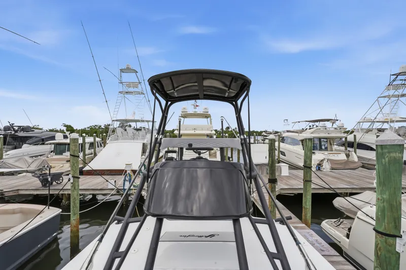 Slide: The Image of 2025 Yellowfin 42 Offshore boat docked at a marina, surrounded by other vessels. - 55
