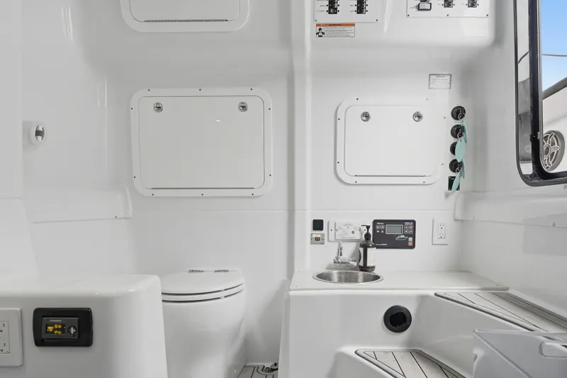 Slide: The Image of 2025 Yellowfin 42 Offshore boat interior with sink, toilet, and control panel. - 30