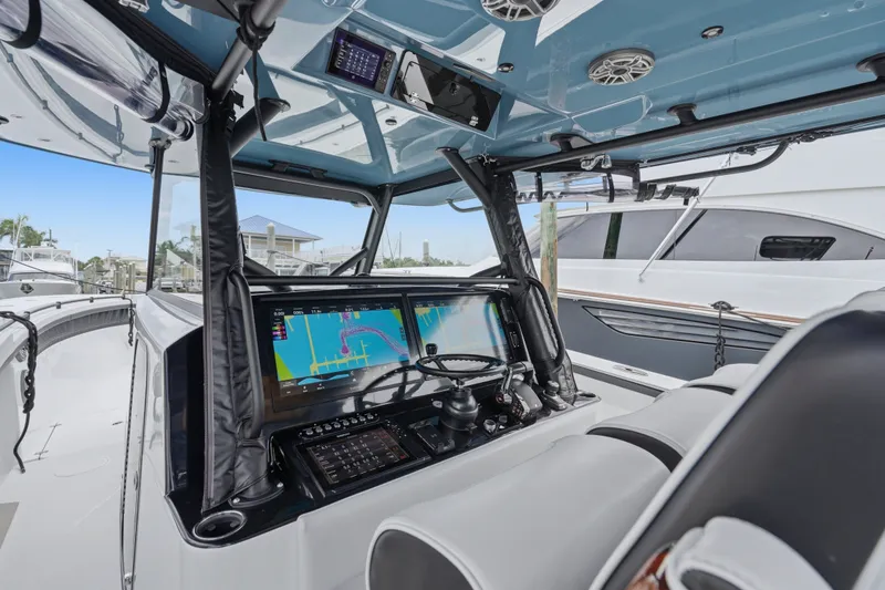 Slide: The Image of 2025 Yellowfin 42 Offshore boat cockpit with advanced navigation system and sleek design. - 45