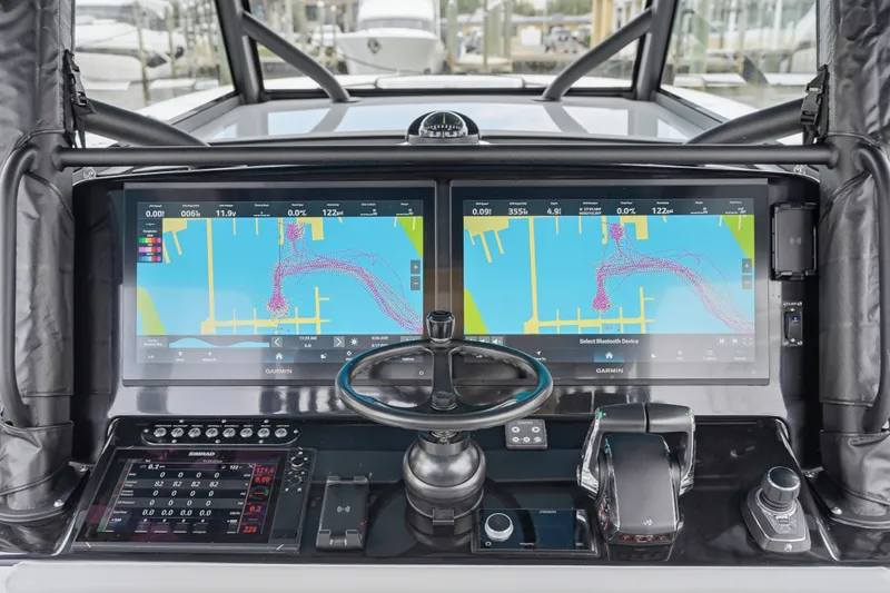 Slide: The Image of 2025 Yellowfin 42 Offshore helm with dual Garmin displays and advanced navigation controls. - 61