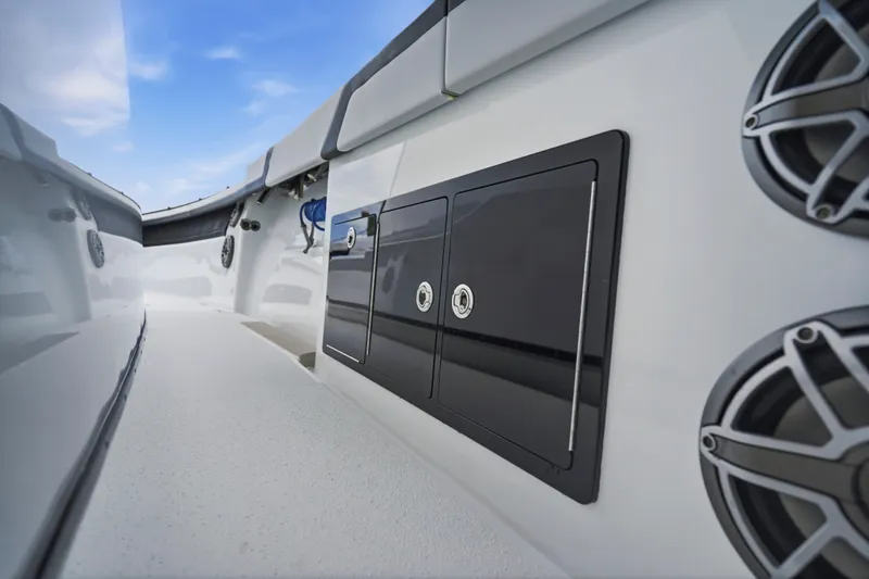Slide: The Image of 2025 Yellowfin 42 Offshore boat interior with storage compartments and speakers. - 25