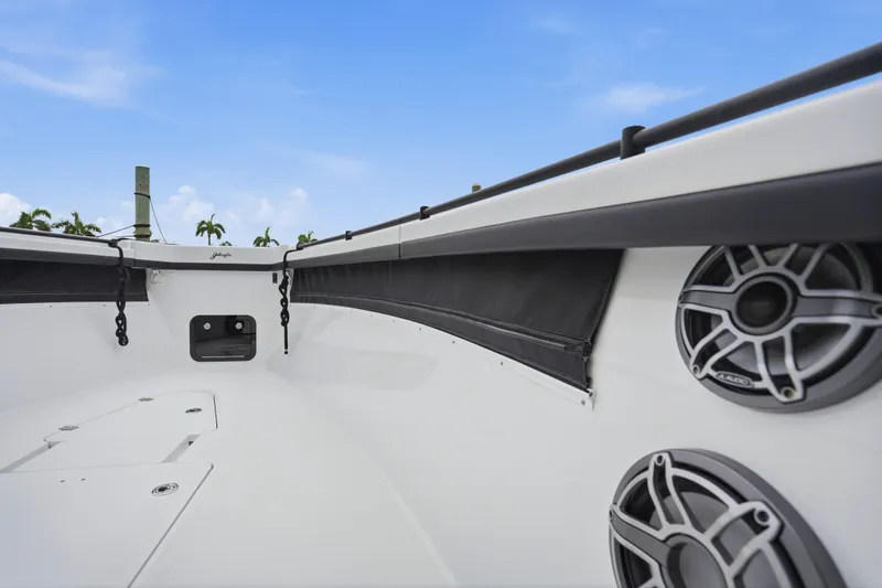 Slide: The Image of 2025 Yellowfin 42 Offshore boat interior with speakers, sleek design, and clear blue sky. - 24