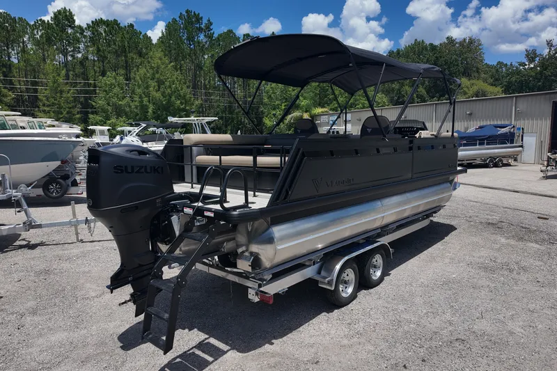 Slide: The Image of 2027 Viaggio V22S pontoon boat with Suzuki engine on trailer, parked outdoors. - 2