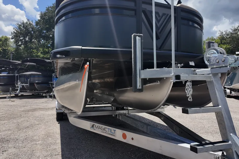 Slide: The Image of 2027 Viaggio V22S pontoon boat on trailer, parked outdoors under a cloudy sky. - 17