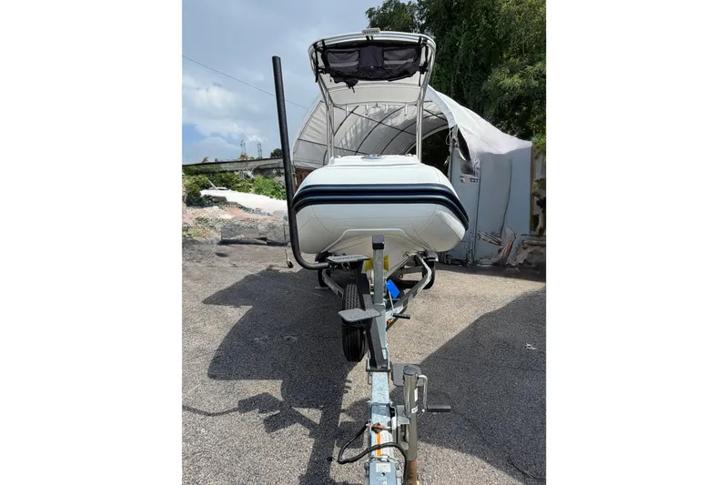 Slide: The Image of 2023 AB Inflatables Nautilus 14 DLX boat on trailer, parked outdoors. - 16