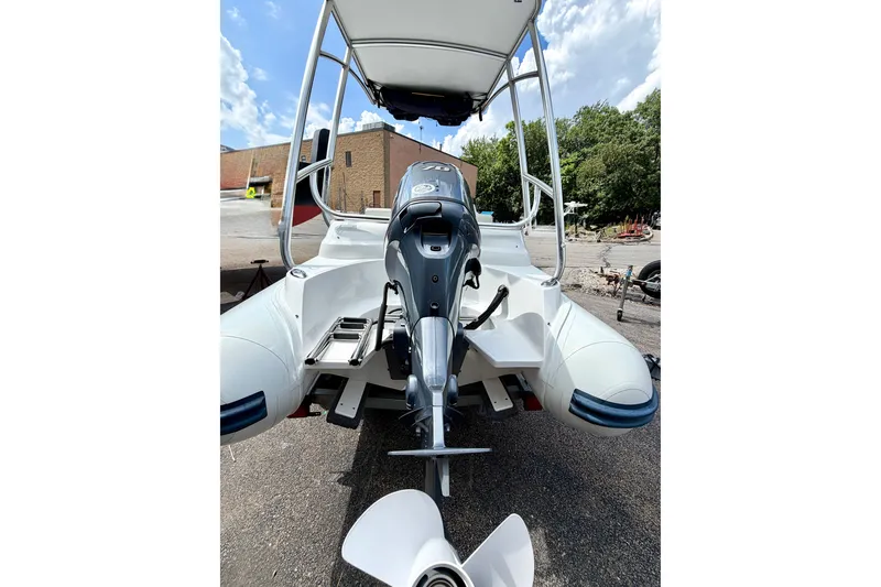 Slide: The Image of 2023 AB Inflatables Nautilus 14 DLX boat with outboard motor, parked outdoors. - 9