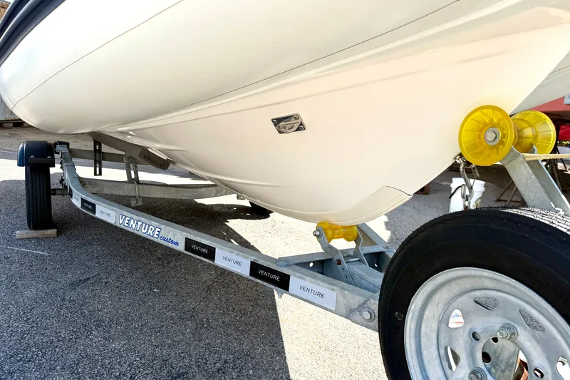 Slide: The Image of 2023 AB Inflatables Nautilus 14 DLX boat on Venture trailer, close-up view. - 14