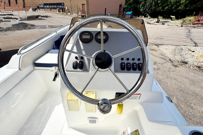 Slide: The Image of 2023 AB Inflatables Nautilus 14 DLX boat dashboard with steering wheel and controls. - 12