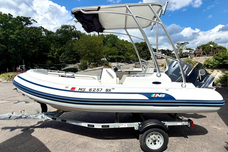 The Image of 2023 AB Inflatables Nautilus 14 DLX boat on trailer, parked outdoors under blue sky. - 0