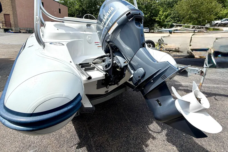 Slide: The Image of 2023 AB Inflatables Nautilus 14 DLX with Yamaha outboard motor, parked outdoors. - 7