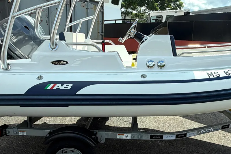Slide: The Image of 2023 AB Inflatables Nautilus 14 DLX boat on trailer, side view. - 1