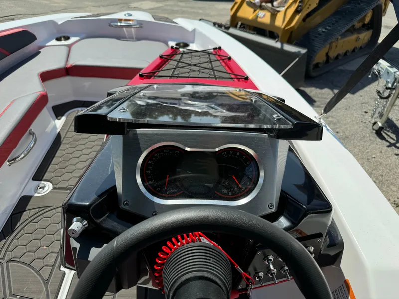 Slide: The Image of 2025 Scarab 165 ID boat dashboard with steering wheel and instrument panel. - 10