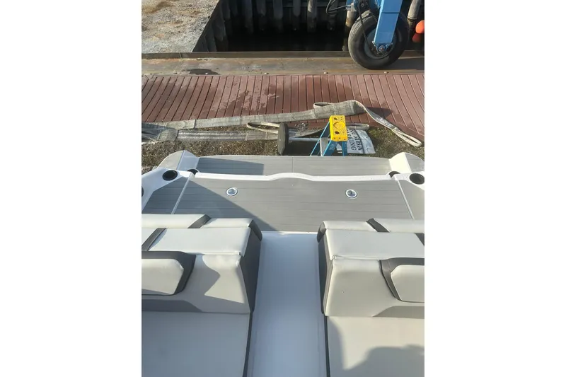 Slide: The Image of 2025 Yamaha Boats AR220 swim platform with cushioned seating and cup holders. - 6