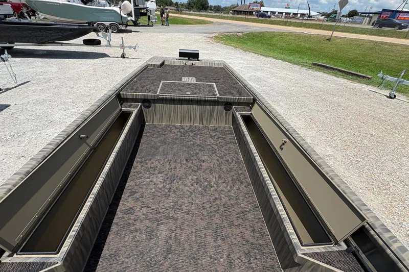 Slide: The Image of 2027 Gator Tail 1860 boat interior with open storage compartments on a sunny day. - 12