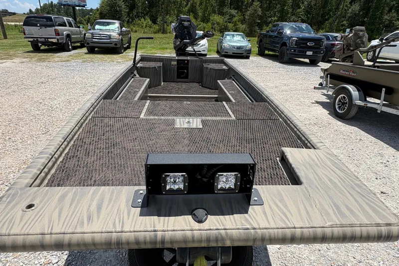 Slide: The Image of 2027 Gator Tail 1860 boat with spacious deck, parked outdoors. - 4