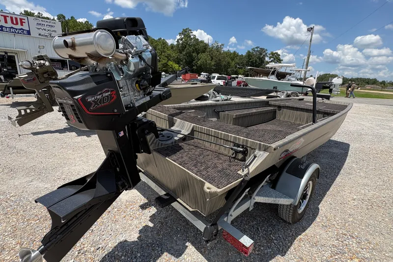 Slide: The Image of 2027 Gator Tail 1860 boat with XD3 motor on a trailer, parked outdoors. - 3