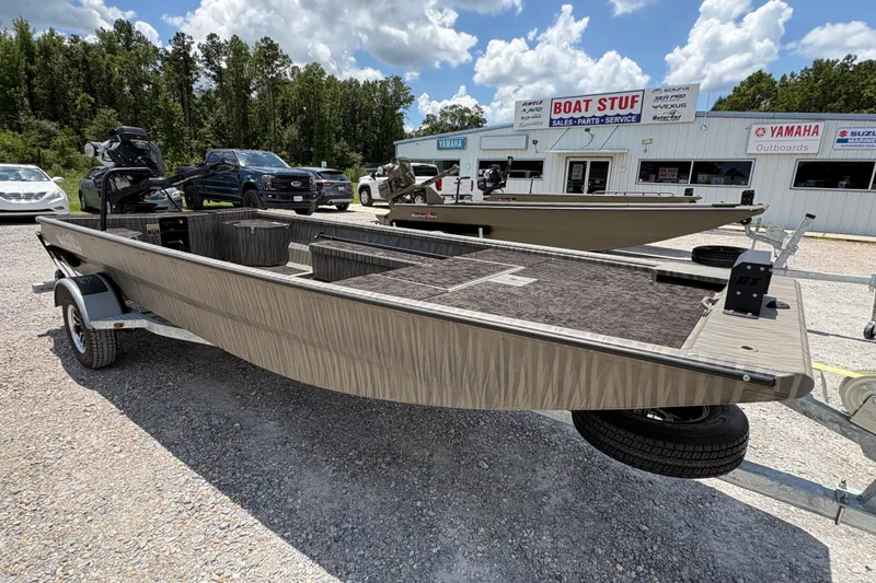 Slide: The Image of 2027 Gator Tail 1860 boat on trailer at dealership, surrounded by vehicles and trees. - 1