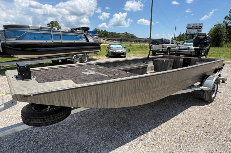 Slide: The Image of 2027 Gator Tail 1860 boat on trailer, parked outdoors under a clear blue sky. - 2