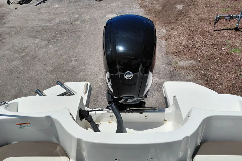Slide: The Image of 2022 Bayliner Element E18 boat with a powerful outboard motor, viewed from the rear. - 25