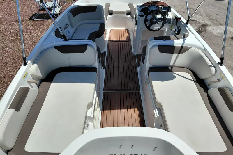 Slide: The Image of 2022 Bayliner Element E18 boat interior with spacious seating and modern dashboard. - 29