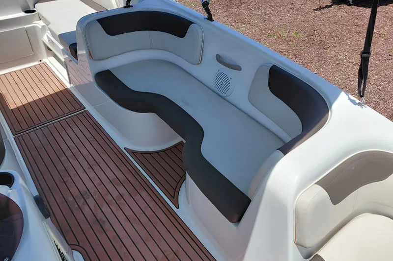 Slide: The Image of 2022 Bayliner Element E18 boat interior with cushioned seating and wood-style flooring. - 15