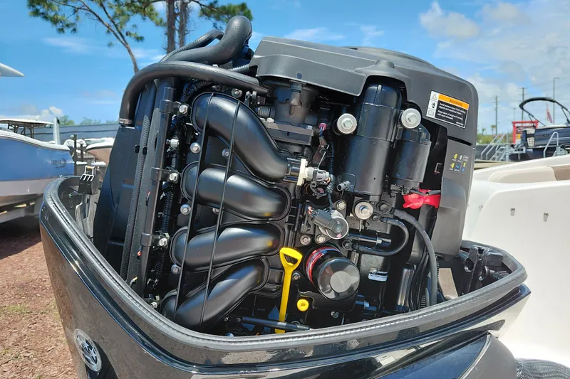 Slide: The Image of 2022 Bayliner Element E18 boat engine, detailed view under sunny sky. - 32