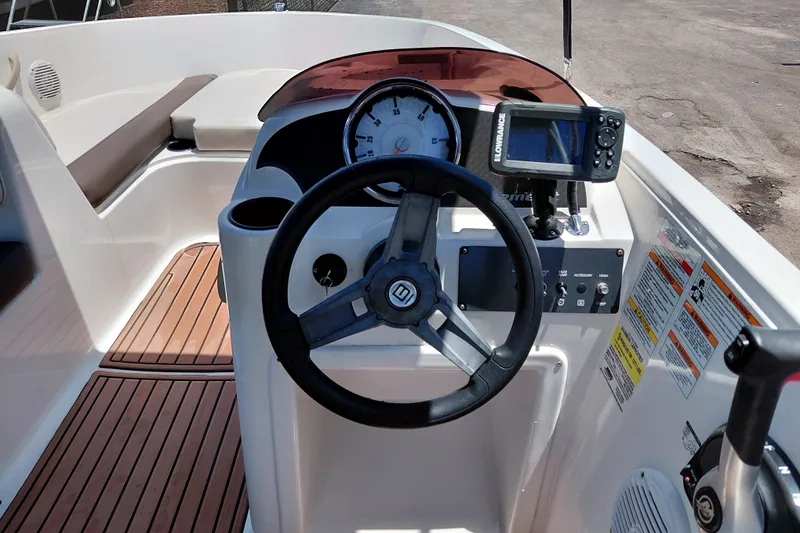 Slide: The Image of 2022 Bayliner Element E18 boat dashboard with steering wheel and navigation system. - 17