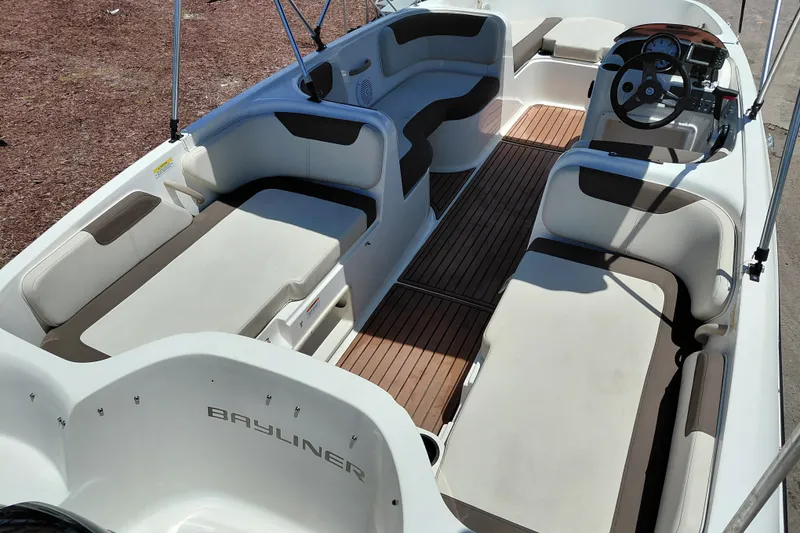 Slide: The Image of 2022 Bayliner Element E18 boat interior with spacious seating and modern dashboard. - 27