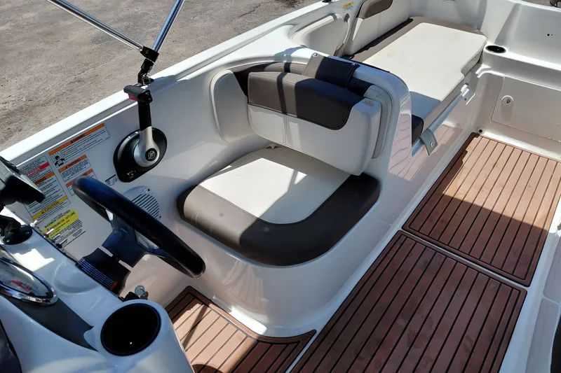 Slide: The Image of 2022 Bayliner Element E18 boat interior with seating and wood-style flooring. - 20
