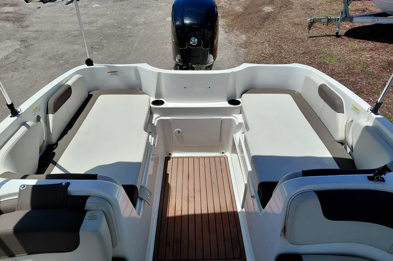 Slide: The Image of 2022 Bayliner Element E18 boat interior with spacious seating and wood-style flooring. - 21
