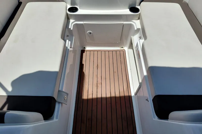 Slide: The Image of 2022 Bayliner Element E18 boat interior with wood flooring and seating area. - 24
