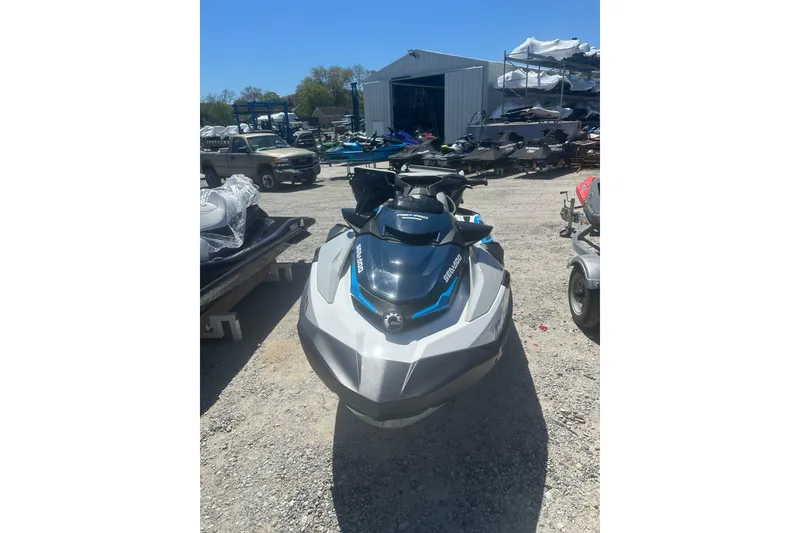 Slide: The Image of 2024 Sea-Doo FishPro Sport 170 jet ski parked outdoors on gravel. - 2