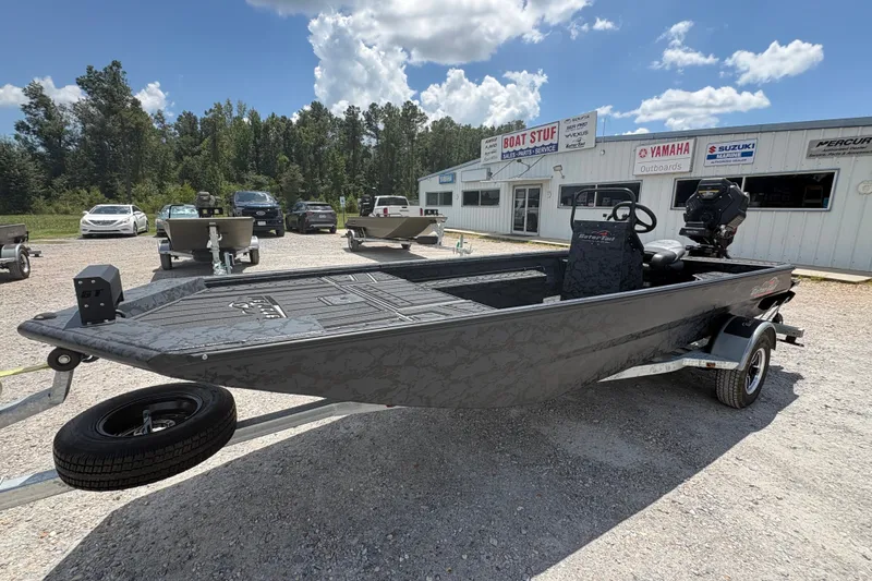 Slide: The Image of 2027 Gator Tail 1860 CC Extreme boat on trailer, parked outside dealership under blue sky. - 2