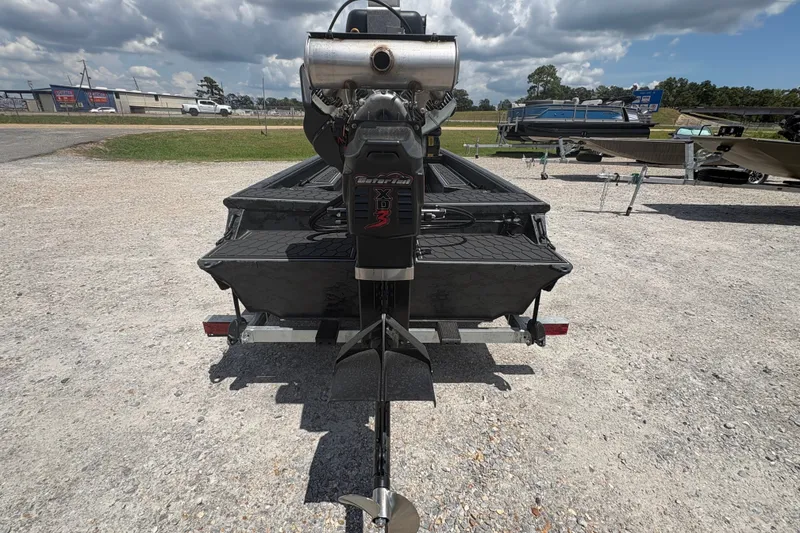 Slide: The Image of 2027 Gator Tail 1860 CC Extreme boat with powerful outboard motor, parked on gravel lot. - 7