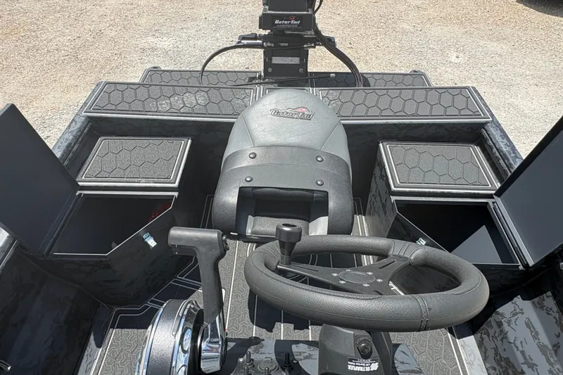 Slide: The Image of 2027 Gator Tail 1860 CC Extreme boat interior with steering wheel and storage compartments. - 12