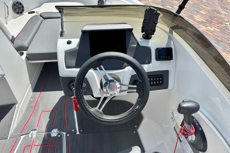 Slide: The Image of 2023 Tahoe 210 S Limited boat cockpit with steering wheel and control panel. - 19
