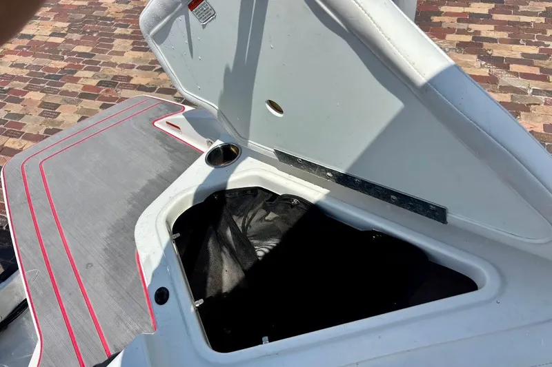Slide: The Image of Open storage compartment on 2023 Tahoe 210 S Limited boat, featuring sleek design and red accents. - 18